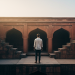 Deep stone stepwell arches of Agrasen Ki Baoli in Delhi illuminated by warm morning sunlight.